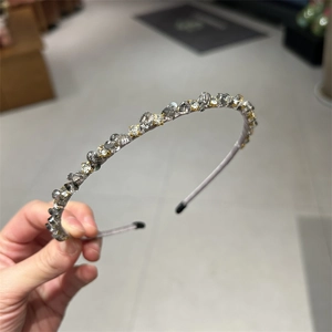 Elegant thin headband with sparkling crystals and rhinestones on a grey silk base wrap