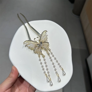 Elegant butterfly hair stick with gold metal frame, pearls and rhinestone details