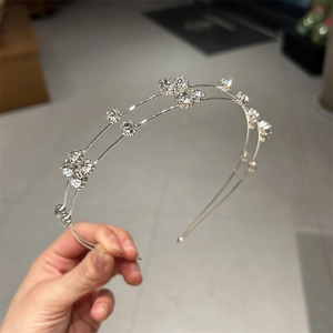 Detailed view of silver double-layered headband with sparkling rhinestones and metal wire