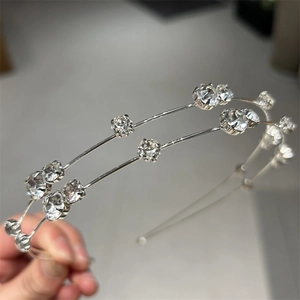 Detail shot of double-layer silver headband with sparkling rhinestones and metal finish