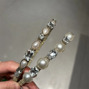 Detail of elegant gold headbands with faux pearls and crystals in a vintage French style