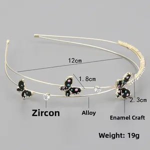 Detail of double-layer gold butterfly headband with zircon stones and colorful polka dots