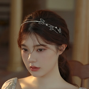 Detail of vintage double-layered butterfly headband with zircons worn by a model