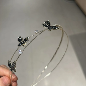 Detail view of double-layer silver headband with black enamel butterflies and zircons