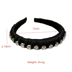 Detail view of black satin headband with dimensions 13cm diameter and 2.18cm width
