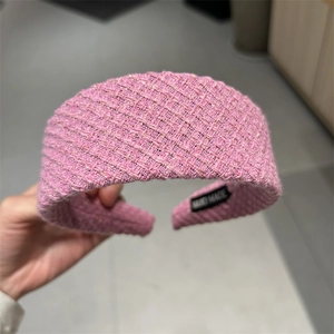 Detail of pink tweed headband with golden threads and black non-slip lining