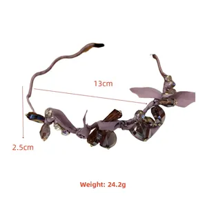 Detail view of purple silk bow headband with crystal beads showing 13cm diameter size