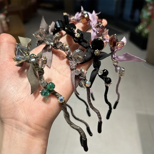Detail of beaded headbands with crystal flowers and satin bows in various colors
