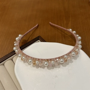 Detailed view of hand-woven pink headband with white pearls and clear crystal beads
