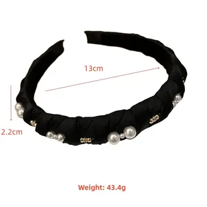 Detail view of black satin headband showing 13cm diameter and 2.2cm width measurements