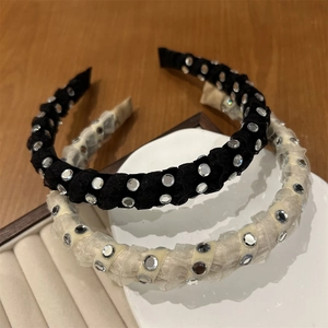 Elegant pleated fabric headbands in black and beige with sparkling silver accents