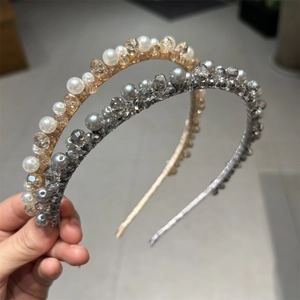 Close-up of handmade crystal and pearl headband featuring gold and silver intricate beadwork