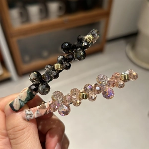 Detailed close-up of handmade floral fabric hair clips with faceted crystal beads