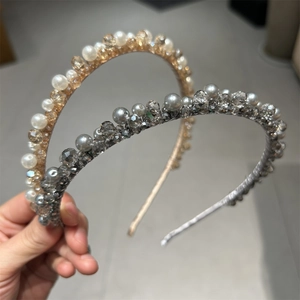 Detail of luxury handmade headbands with delicate pearls and faceted crystals on metal frames