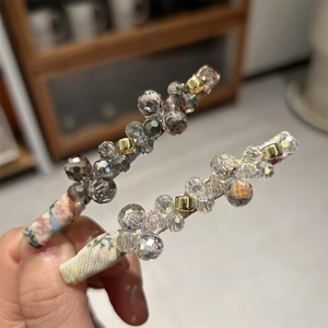 Detail of handmade hair clips with faceted crystal beads and floral fabric base