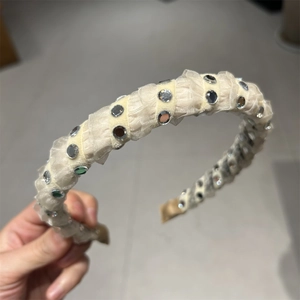 Elegant beige fabric headband featuring reflective circular sequins for a chic vintage look