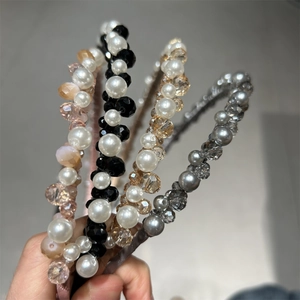Detail of four handmade headbands featuring crystals and pearls in assorted colors