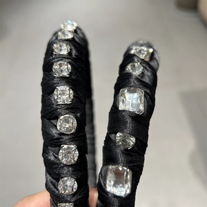 Close-up of black satin headband featuring hand-set crystals in various shapes and cuts