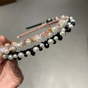 Detail of handmade crystal headbands featuring elegant pearls and faceted beads in close-up
