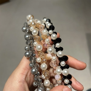 Detailed view of handmade beaded crystal headbands in grey, champagne, white and black