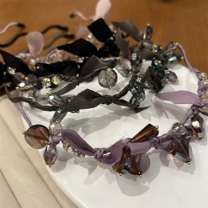 Detail of handcrafted crystal beaded headbands with silk ribbons and luxury gemstones