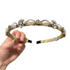 Vintage gold headband featuring teardrop pearls and sparkling crystals on a metal base