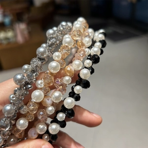 Close-up of handmade crystal and faux pearl beaded headbands in four elegant colors