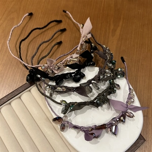 Close-up of assorted slim headbands with silk ribbons and faceted crystal beads