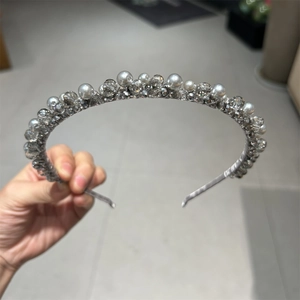 Close-up of handmade luxury headband with silver wire wrapped pearls and crystals