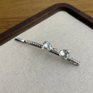 Elegant crystal bow hair clip with silver metal and sparkling rhinestone decorations