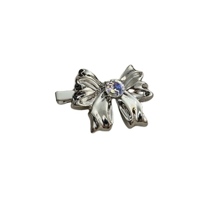 Silver bow hair clip with crystal rhinestone center for women in minimalist metal style
