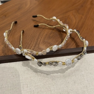 Detailed macro view of handmade gold-wrapped headbands with pearls and crystals
