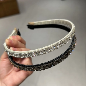 Detail of silver and black headbands featuring densely inlaid sparkling rhinestones