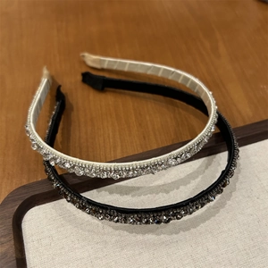 Detail of luxury thin headbands with sparkling rhinestones in silver and black colors