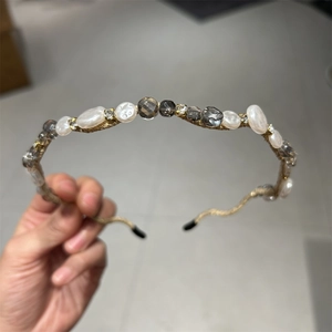Detail of thin gold headband with handmade white pearls and grey faceted crystals