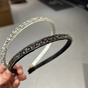 Detailed close-up of double rhinestone headbands in silver and grey with soft fabric lining