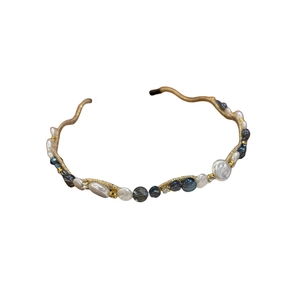 Elegant gold wavy headband with baroque pearls, navy beads and crystals on white background