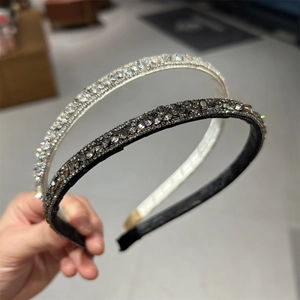 Detail of two luxury rhinestone headbands in silver and dark gray showing premium craftsmanship