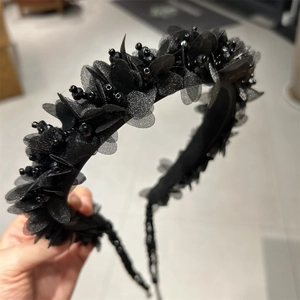 Detailansicht der schwarzen 3D-Stoffblüten mit Perlen und Pailletten auf dem Haarreif