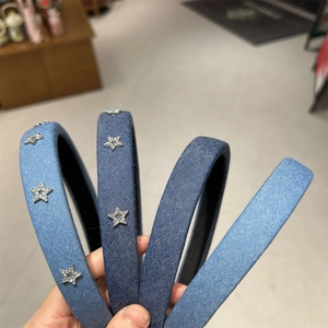 Close-up of denim headband featuring rhinestone star decor and thick cotton padding