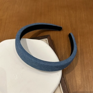 Detail of blue denim headband featuring texture fabric and black non-slip inner lining