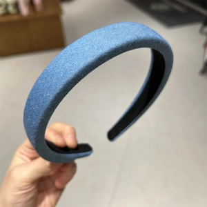 Close-up of light blue denim fabric headband with padded high-top texture design