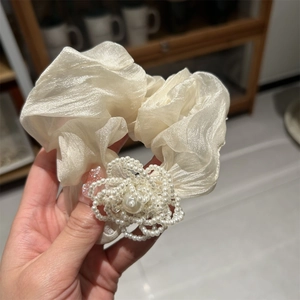 Elegant cream organza scrunchie with a central pearl camellia flower for ponytail styling
