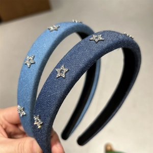 Detailed close-up of denim headbands with sparkling silver zircon star embellishments