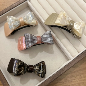Elegant set of four acetate bow hair clips in marble, tortoiseshell and solid colors