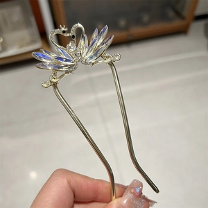 Elegant swan hair pin with rhinestones and iridescent crystals on a gold U-shaped base