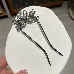 Detailed close-up of swan hair pin featuring silver plating and blue crystal accents