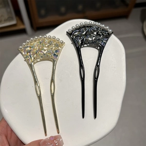Vue détaillée en gros plan d'épingles à cheveux vintage en forme d'éventail avec perles