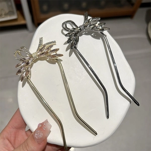Detailed macro of crystal butterfly hairpins with rhinestone wings in gold and silver