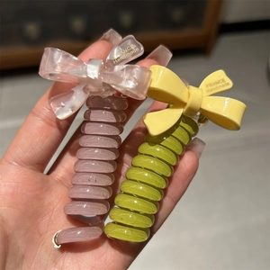Detail of pink and green spiral telephone wire hair ties with handmade bows